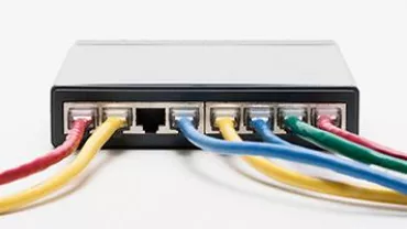 Network switch with colorful Ethernet cables connected.